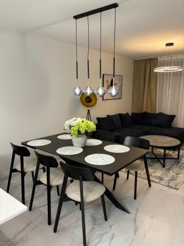 a black dining room table with chairs and a black couch at Flamenca Village- Apartment 459 in Orihuela Costa