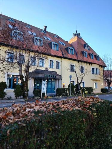 a large white building with a red roof at Queen Lisbeth Street in Keszthely