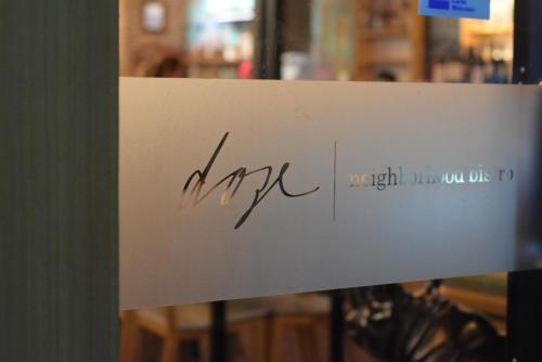 a sign with the word are written on it at Room@Doze in Nonthaburi