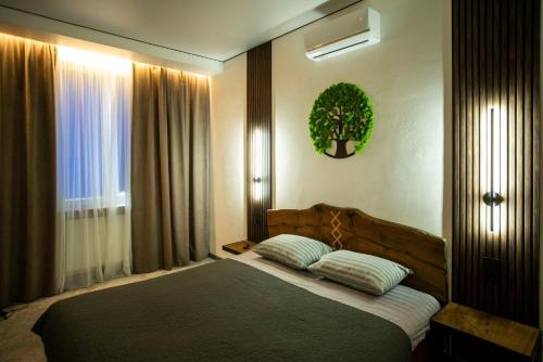 a bedroom with a bed with two pillows on it at Art-House in Uzhhorod