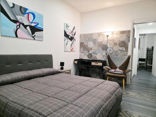 a bedroom with a bed and a desk and a chair at Casa Vacanze 21 Ventuno in Antrodoco