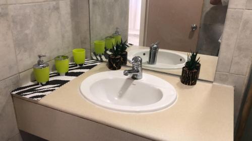 a bathroom counter with a sink and a mirror at אלמוגי אוראל in Eilat