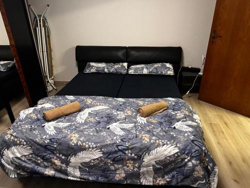 a bed with a blue comforter and two pillows at Dortmund Brackel Wohnung in Dortmund