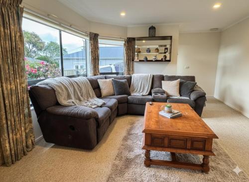 a living room with a couch and a coffee table at Wellington Suburb Stay in Wellington