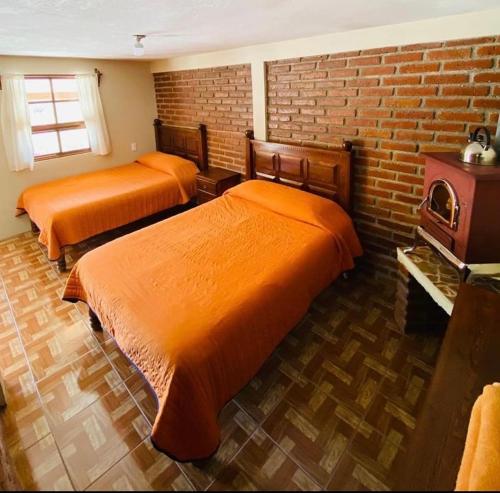 En eller flere senge i et værelse på Cabañas las Gemelas