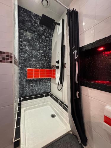 a bathroom with a shower with a tub in it at La Maxipontaine in Pont-Sainte-Maxence