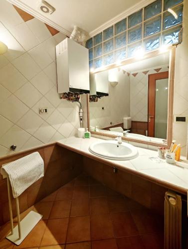 a bathroom with a sink and a mirror at CASA VACANZA Emma in Monfalcone