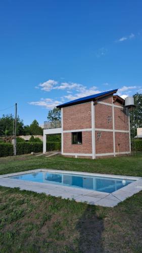 a house with a swimming pool in the yard at Lo de la Abu in Villa Las Rosas