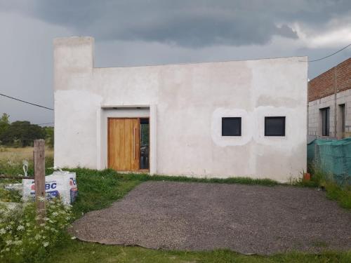 a white house with a door and two windows at Casa Aramí in Victoria