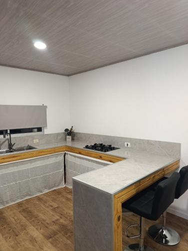 a kitchen with a counter top and a stove at Lofth house in Piriápolis