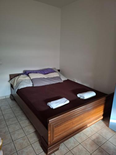 a bed with two towels on it in a room at Nature Nest Više Selo in Blace