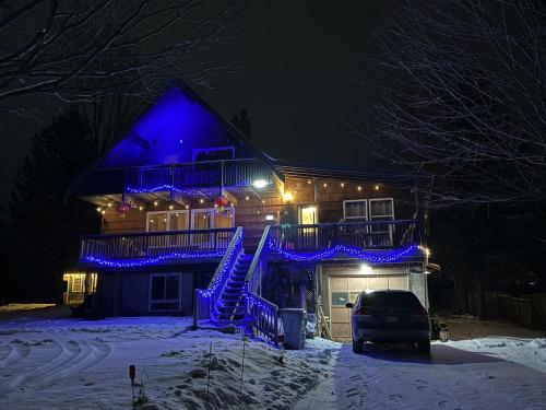een huis met blauwe lichten in de sneeuw bij A fully self-contained one-bedroom apartment in Fredericton