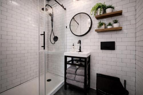 a bathroom with a shower and a sink and a mirror at Artsy Hidden Gem -- FREE PARKING in Philadelphia