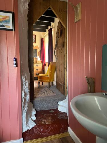 a bathroom with a sink and a bath tub at Lofthouse - secluded quirky cottage with sea views! in Newport