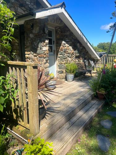 a wooden deck in front of a cabin at Lofthouse - secluded quirky cottage with sea views! in Newport