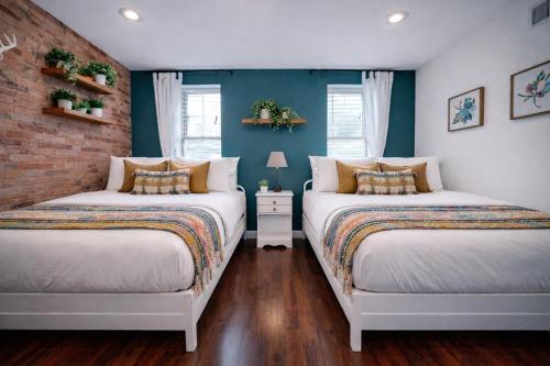 two beds in a room with blue walls at Artsy Hidden Gem -- FREE PARKING in Philadelphia