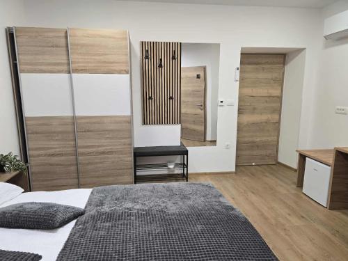 a bedroom with a bed and a desk and a chair at Prenočišca Dany 3 in Dravograd