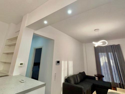 a living room with a black chair and a window at VASKO Luxury Suites 3 in Siátista