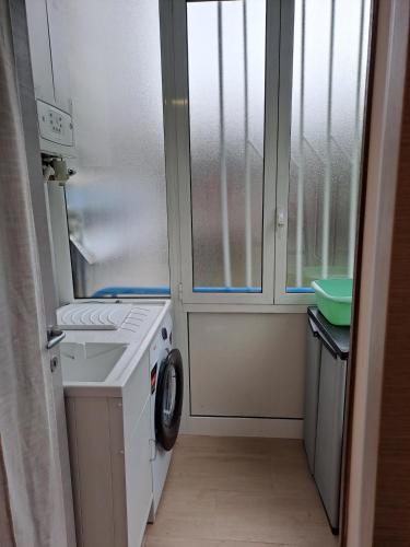 a laundry room with a washing machine and a window at Vista Garda, Casa Vacanze in Roe