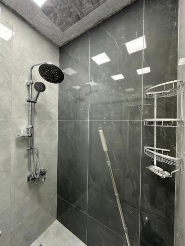 a bathroom with a shower with a glass door at Sultan Villas A-Frame in Quba in Quba