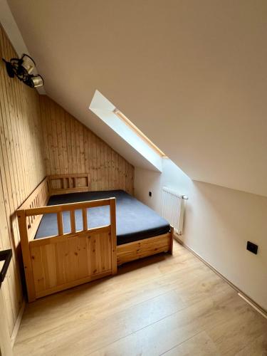 a bedroom with a bed in a attic at Chalupa Bohunka in Kašperské Hory