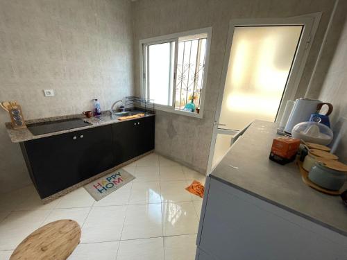 a kitchen with a sink and a counter top at Appartement à Skhirat plage in Skhirat