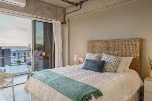a bedroom with a large bed with a large window at Spacious 2BR 2BTH El Zonte with oceanview and pool in El Zonte