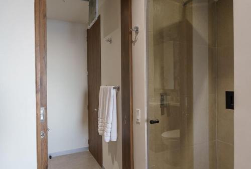 a bathroom with a shower with a glass door at Spacious 2BR 2BTH El Zonte with oceanview and pool in El Zonte