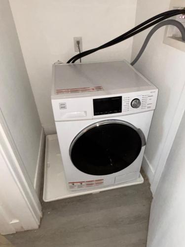 a microwave sitting in the corner of a room at Nice escape 8 min from EWR in Elizabeth