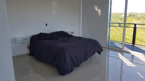 En eller flere senge i et værelse på Punta El Tesoro - Playa Privada al Lago