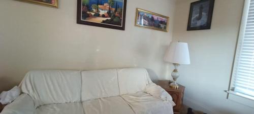 een witte bank in een woonkamer met foto's aan de muur bij Historic Reno Home in Reno