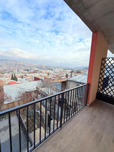 a balcony with a view of a city at Cosy City-View Flat in Mtatsminda, flat 6 in Itʼkhvisi