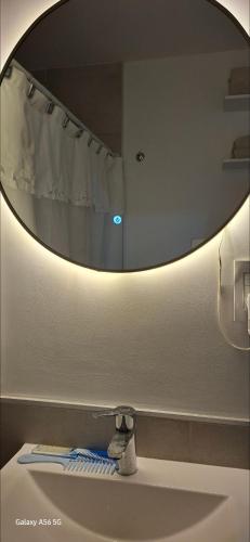 a bathroom with a mirror over a bathroom sink at DEPARTAMENTO a ESTRENAR - TUCUMAN in San Miguel de Tucumán