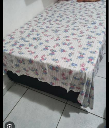 a bed with a quilt on top of it at Rhanna dunas in Barreirinhas