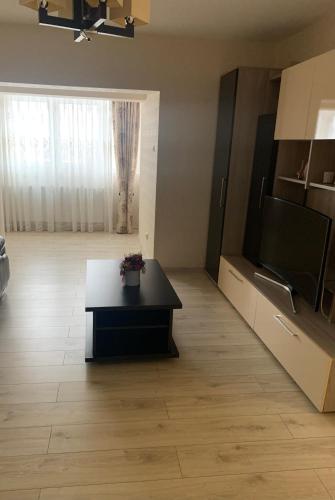 a living room with a coffee table and a flat screen tv at Apartament central in Ploieşti