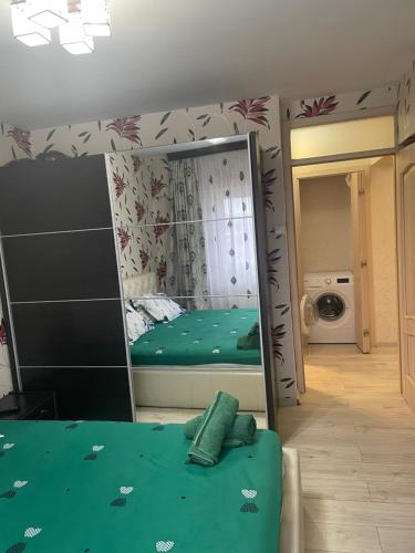 a bedroom with a mirror and a bed in it at Apartament central in Ploieşti