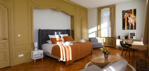 a bedroom with a bed and a living room at Hôtel Séquoias in Ruy