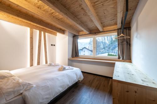 a bedroom with a large bed and a window at - Punta Penia - Canazei center app in Canazei