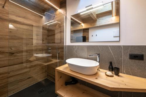 a bathroom with a sink and a glass shower at - Punta Penia - Canazei center app in Canazei