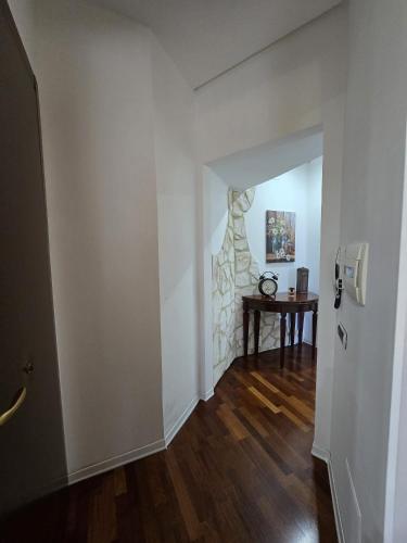 an empty hallway with a table and a stone wall at Narni Come a casa dei nonni in Fiaiola