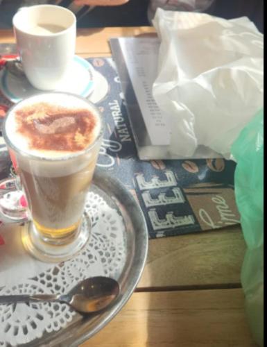 a cup of coffee sitting on a table with a spoon at Blankenbeach-50m from Beach & Casino in City Center in Blankenberge