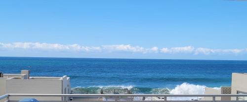 a view of the ocean from the balcony of a building at Sunseaker- Beachfront Complex in Ballito