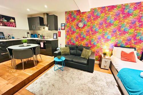 a living room with a couch and a kitchen at Rainbow Studio By My Getaways in Brighton & Hove