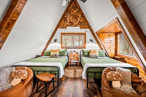 a room with two beds and chairs in a attic at High Bear Activity, Handicap Ramp, Hot Tub, Fire Table, Game Room, Family Cabin in Gatlinburg