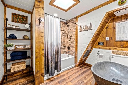 a bathroom with a tub and a toilet and a sink at High Bear Activity, Handicap Ramp, Hot Tub, Fire Table, Game Room, Family Cabin in Gatlinburg