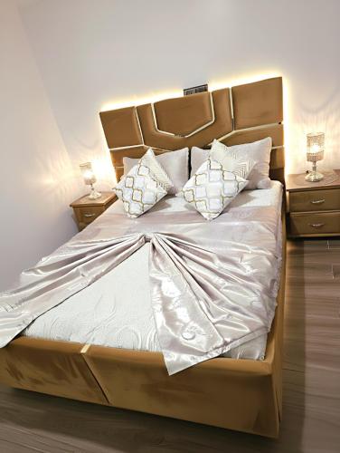 a large bed with white sheets and pillows on it at Ray CaboNegro Sea & Pool View in Cabo Negro