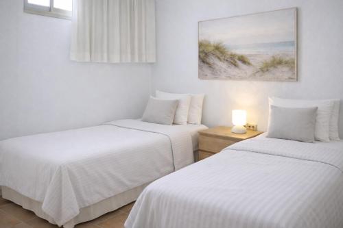 Giường trong phòng chung tại Casa Médano 34