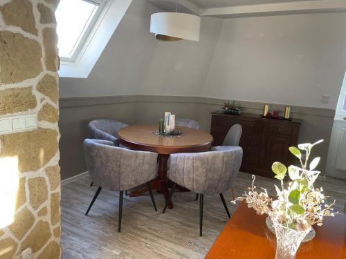 a dining room with a wooden table and chairs at Ferienwohnung Maria mit Elbblick in Coswig