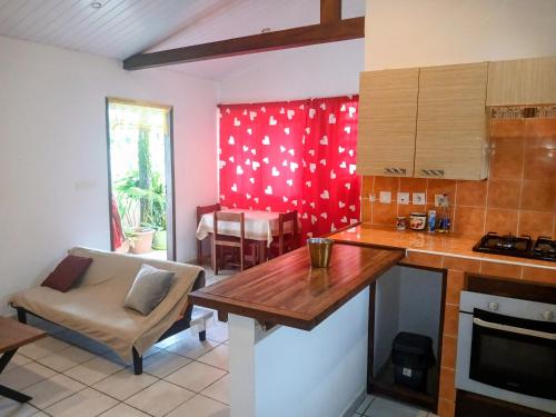 a kitchen with a table and a couch in a room at Le Milano in Kourou