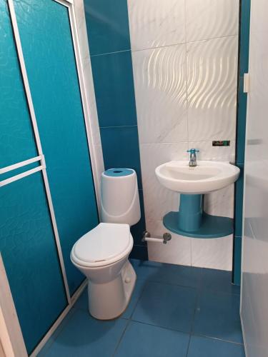 a bathroom with a toilet and a sink at Cabin near the beach in El Valle